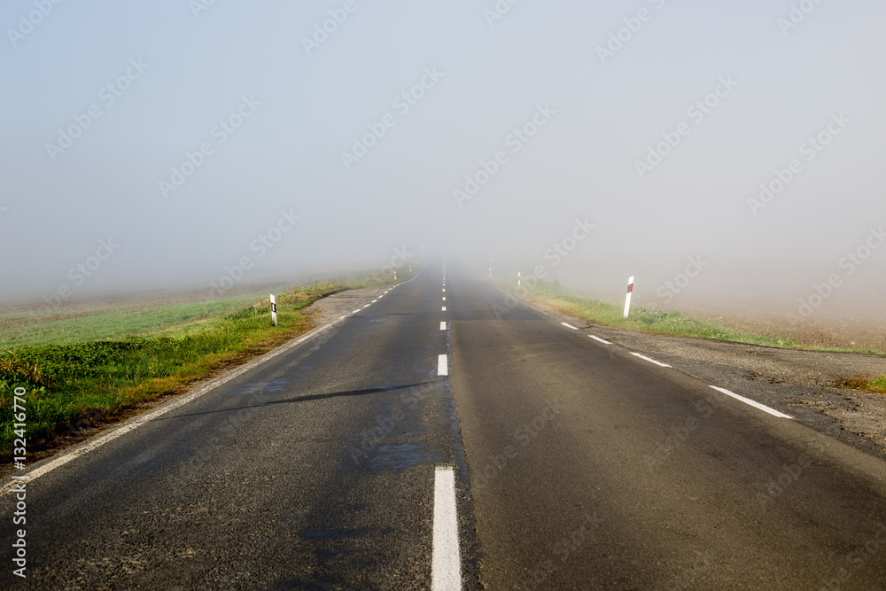 Empty long highway with fog