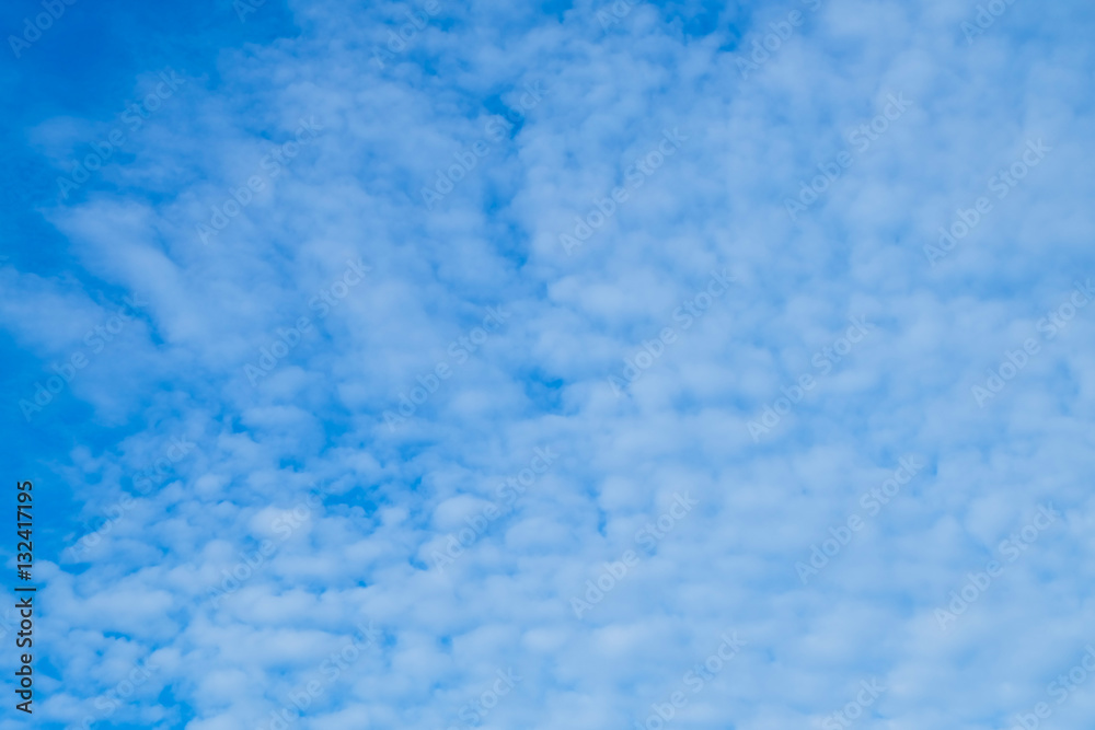 Blue sky background with tiny clouds