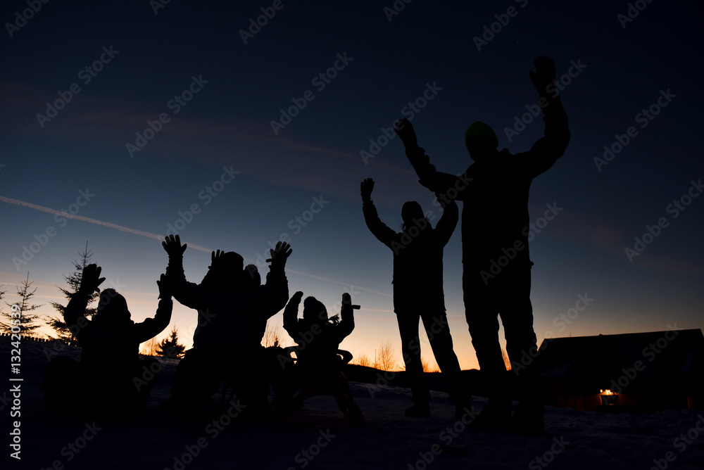 Silhouette of a family at sunset. Parents with kids having fun Silhouette of a family at sunset. Parents with kids having fun