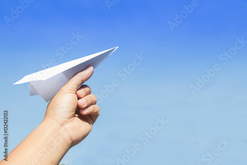 Hand holding rocket paper with blue sky. concept freedom