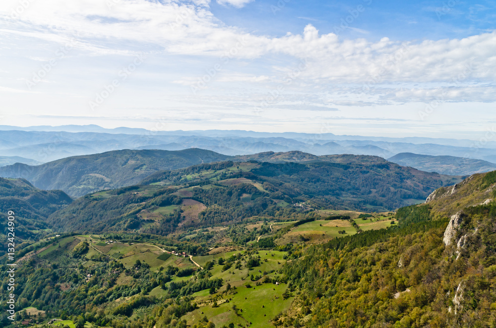 Viewpoint on a landscape of mount Bobija, peaks, hills, meadows and green forests, west Serbia