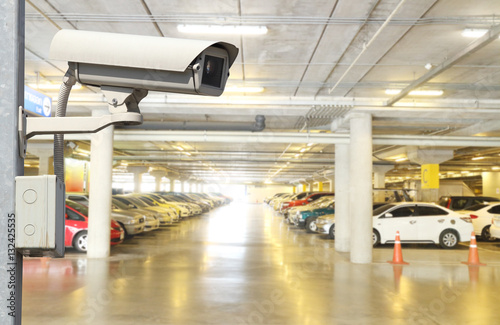 CCTV security camera on blur car parking