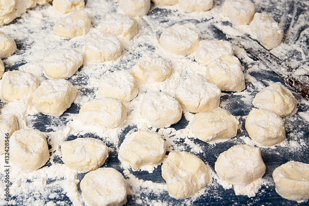 Making homemade gnocchi. Uncooked trickled pastries in flour