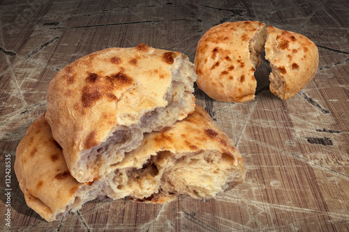 Pitta Bread Torn Loaves Set on Old Rustic Cracked Flaky Wooden Garden Table