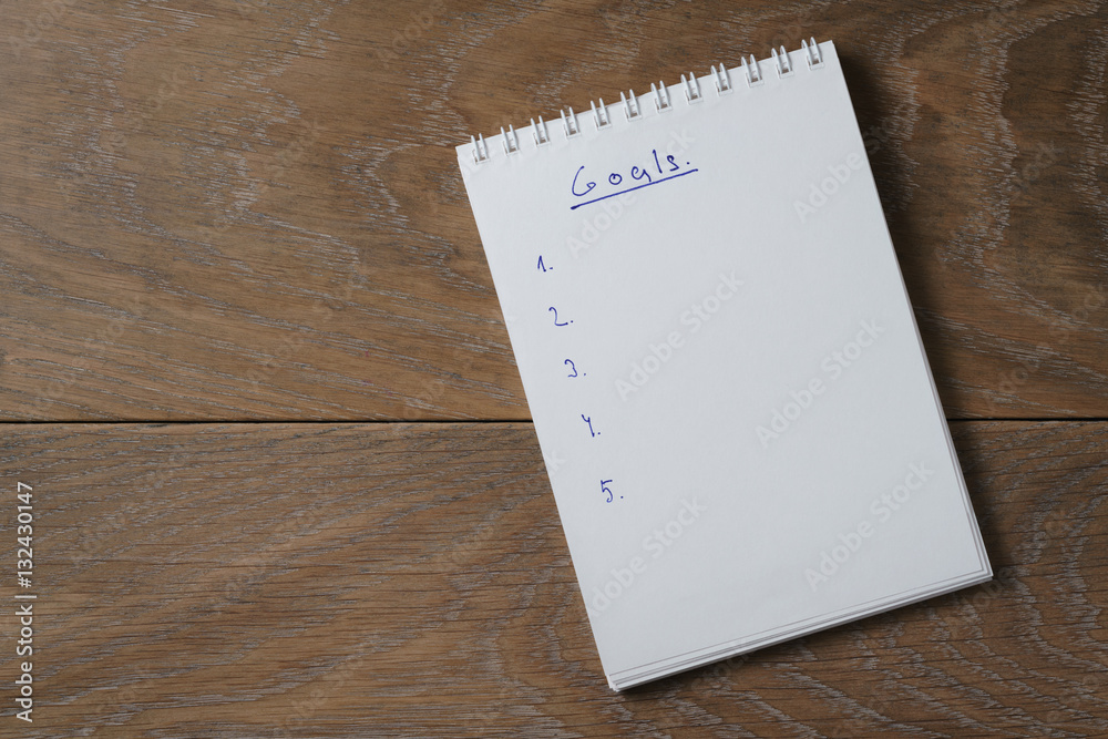 blank notepad on wooden table with word goals, space for your text blank notepad on wooden table with word goals, space for your text