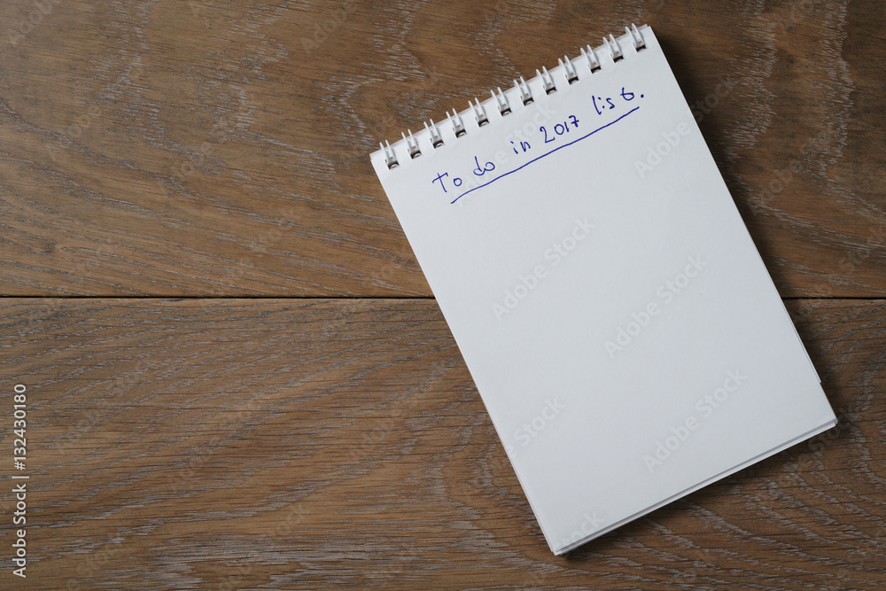 blank notepad on wooden table with phrase to do in 2017, space for your text blank notepad on wooden table with phrase to do in 2017, space for your text