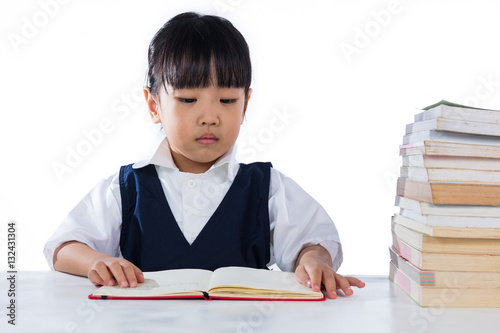 Asian Chinese little girl wearing school uniform studying