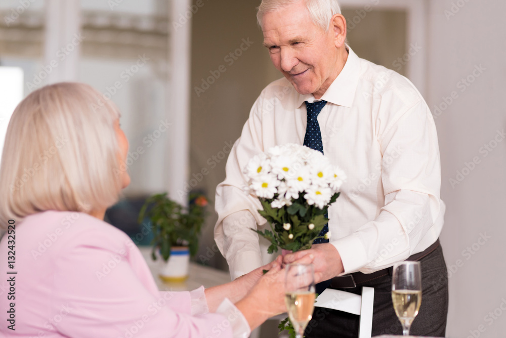 Gallant handsome man giving flowers Gallant handsome man giving flowers