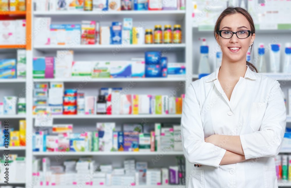 
Cheerful pharmacist chemist woman standing in pharmacy drugstore
