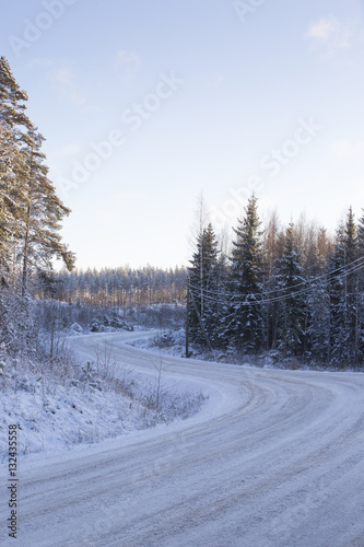 Travel to the winter wonderland. Curvy and snowy road in the countryside.