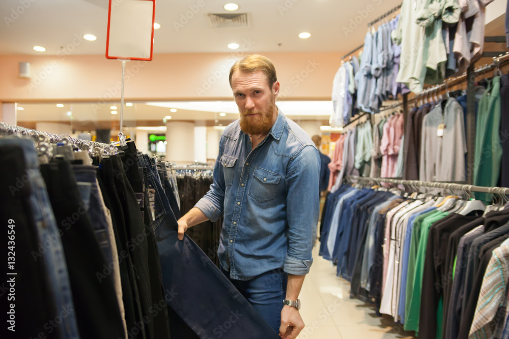  Young man in   men's clothing store.