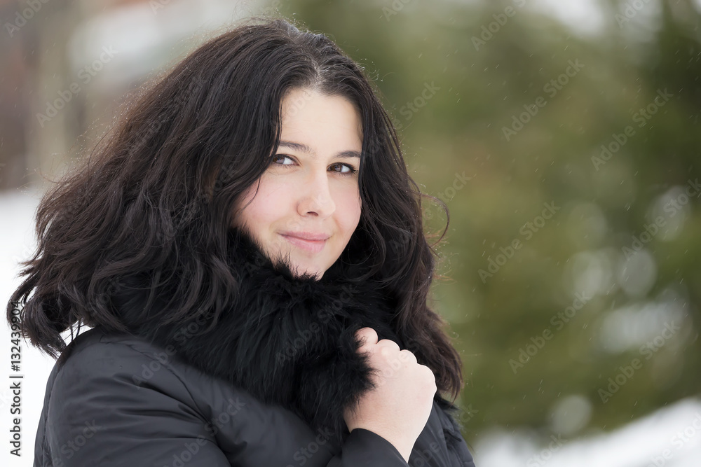 Winter portrait of young beautiful brunette woman snood covered in snow. Snowing winter beauty fashion concept