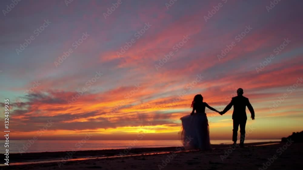 Couple silhouette running away from camera with the sunset Golden hour, the sun a warm color, slow motion Couple silhouette running away from camera with the sunset Golden hour, the sun a warm color, slow motion