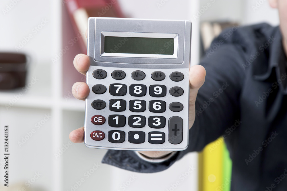 calculator in the hand in first plane calculator in the hand in first plane