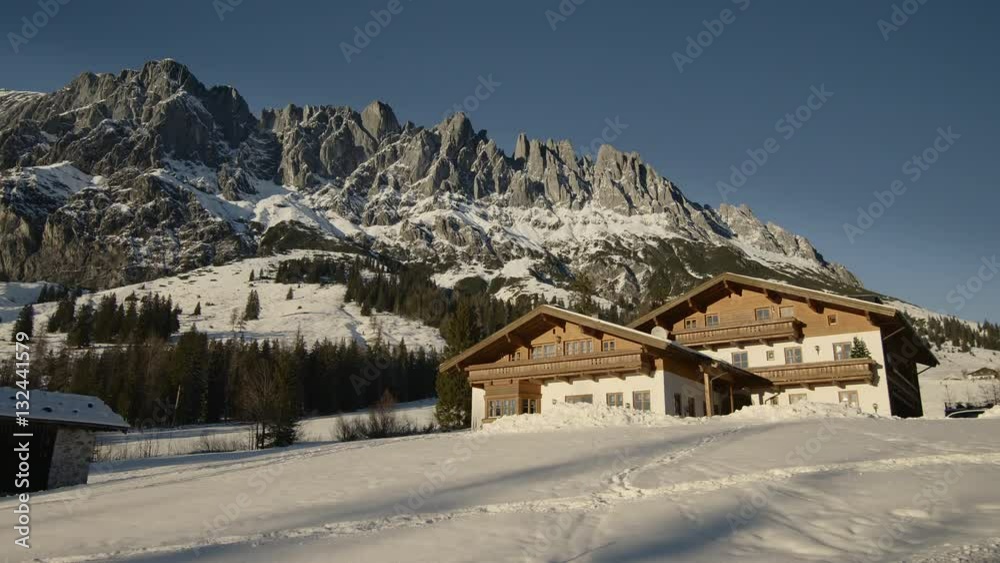Panoramic view of idyllic winter wonderland with mountain tops and traditional mountain chalet in the Alps, Muhlbach Hochkonig skiing resort, Salzburger Land, Alps, Mühlbach, Austria, Europe, Jan 2017