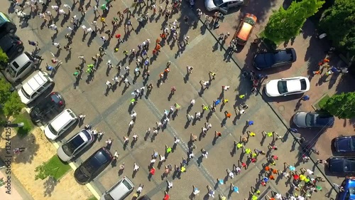 Aerial footage. Vertical rotate camera. Marathon on streets. photo