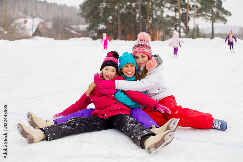 three attractive skater girl sitting on the ice three attractive skater girl sitting on the ice