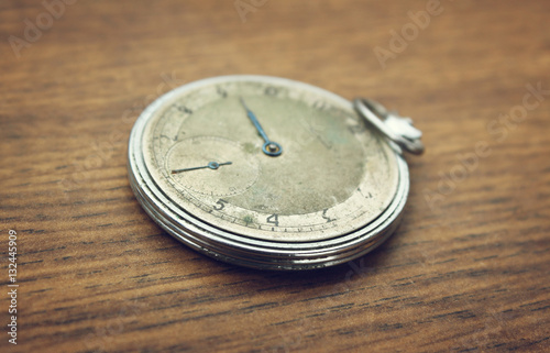 Vintage pocket watch on a wooden background