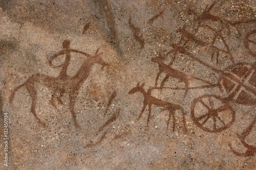 Drawing on a rock cave wall ocher paint  ancient prehistoric Neanderthal man. man surrounded by prehistoric animals  head of intelligence  radiance  lord