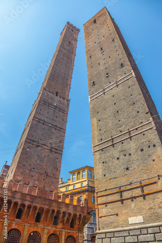 Perspective ground view of Due Torri, symbol of city under blue sky in Bologna, Piazza di Porta Ravegnana, Italy. Torre degli Asinelli and Torre Garisenda in historic center of the city. photo