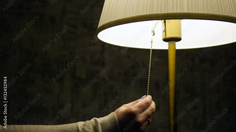 woman's hand turn off the lamp