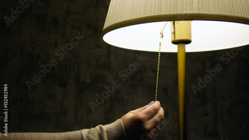 woman's hand turn off the lamp