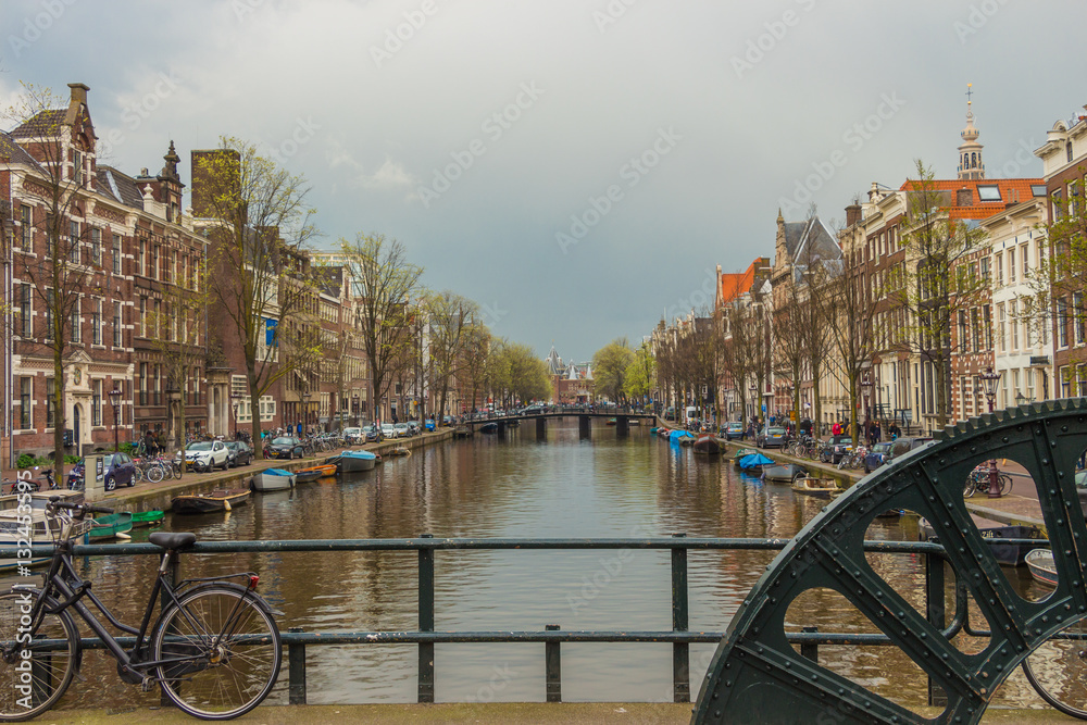 View from brigge with wheel to canal in Amsterdam, Netherlands
