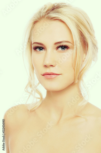 Vintage style portrait of young beautiful blond girl with clear make-up 