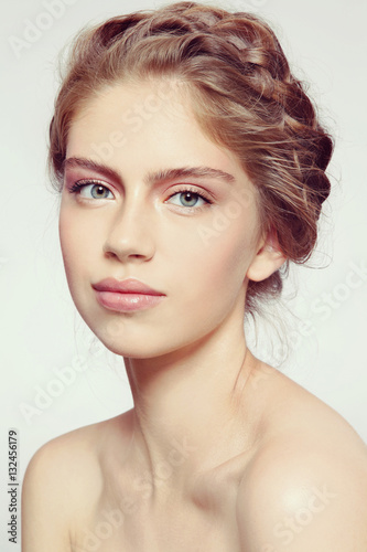 Vintage style portrait of young beautiful smiling healthy girl with clean make-up and braids