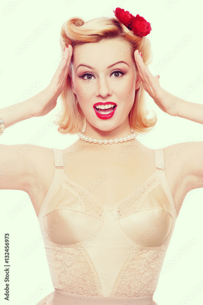 Vintage style portrait of young beautiful sexy excited girl with pin-up make-up and hairdo