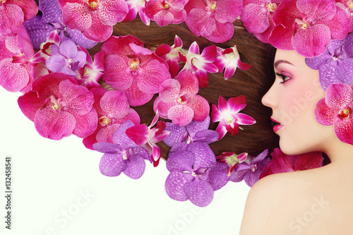 Fototapeta Naklejka Na Ścianę i Meble -  Vintage style profile portrait of young beautiful girl with bright make-up and colorful orchids in her long hair