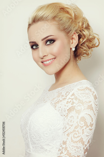 Vintage style portrait of young beautiful blond woman with stylish prom hairdo and smoky eyes