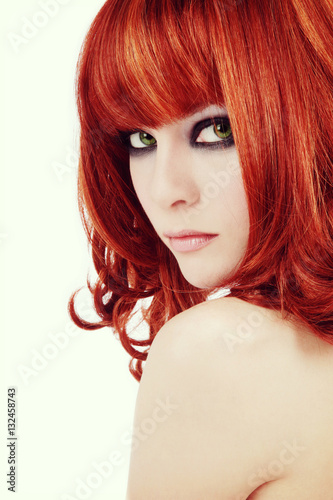 Vintage style portrait of young beautiful red-haired girl with smoky eyes make-up, copy space