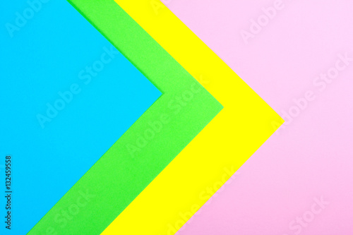 Material design yellow, blue, pink and green paper background. Photo.