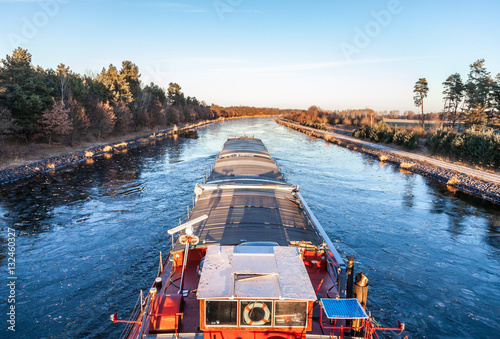 inland vessel drives a canal river along