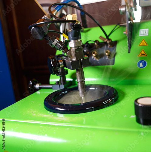 Testing diesel injector in workshop.
