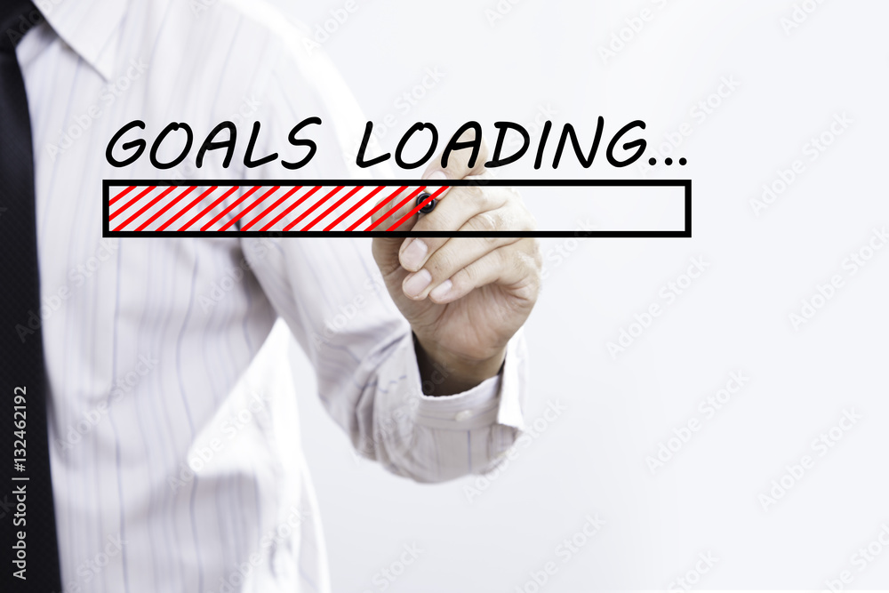 Businessman hand writing goals Loading with red marker on trans Businessman hand writing goals Loading with red marker on trans