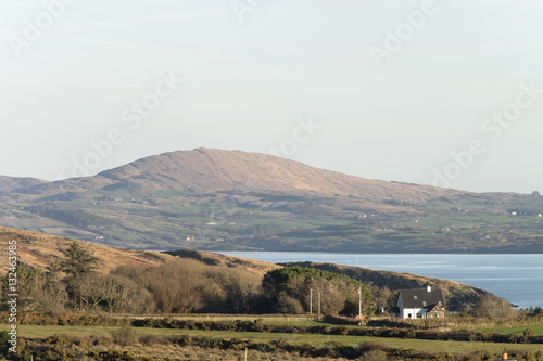 A house on the Sheep's Head Peninsula, County Cork, Ireland with Dunmanus Bay and Mizen Peninsula in the background. photo