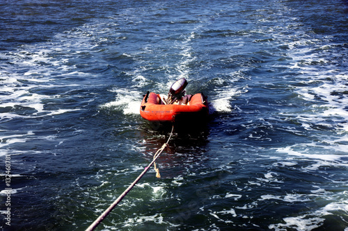 Inflatable dinghy with outboard motor at the wire