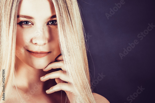 Wallpaper Mural Beautiful young blonde woman with long straight hair on a dark background  Torontodigital.ca