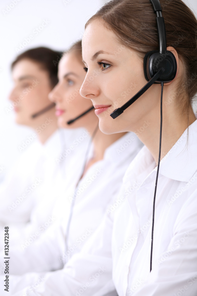 Call center. Focus on beautiful woman in headset Call center. Focus on beautiful woman in headset