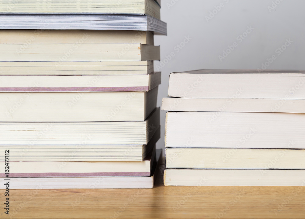 Books stacked on a wooden table. Books stacked on a wooden table.