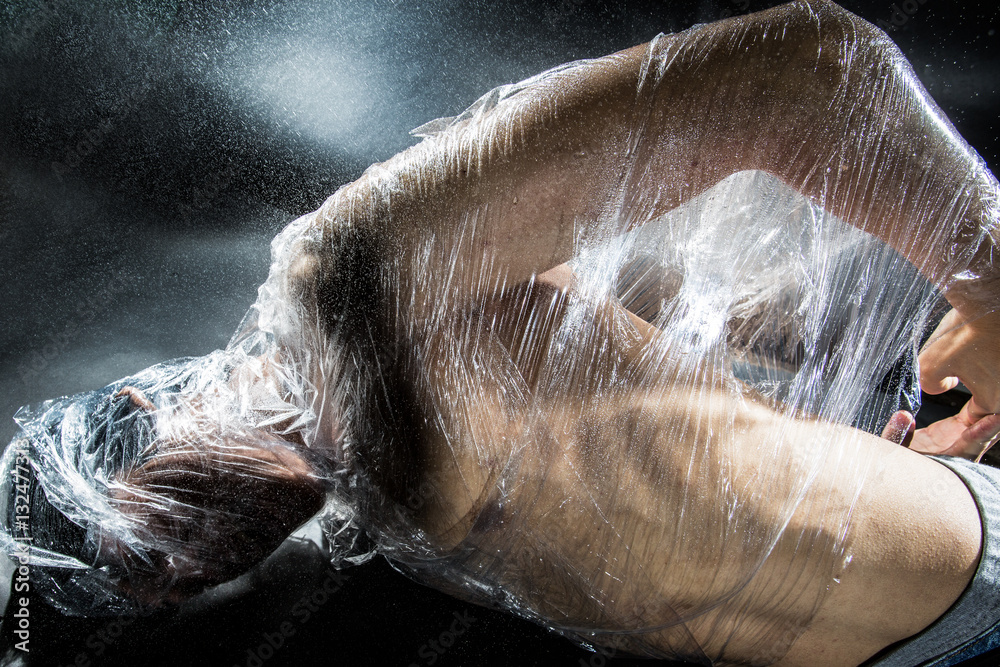 person trapped in plastic sheets