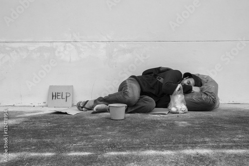 Homeless person sleep on sidewalk of the street 