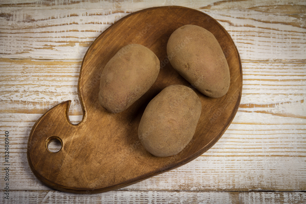 Organic Red Potatoes on chopping board Organic Red Potatoes on chopping board