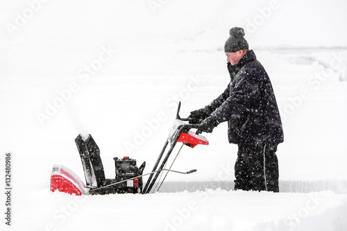 Man using a snowblower photo