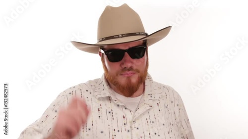 Hipster millennial cowboy tipping his cowboy hat with sunglasses on