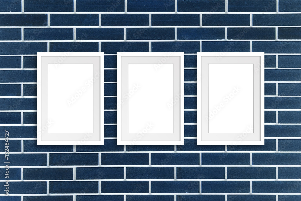 Three white frames on navy blue decorative bricks wall, Exhibition style mock up