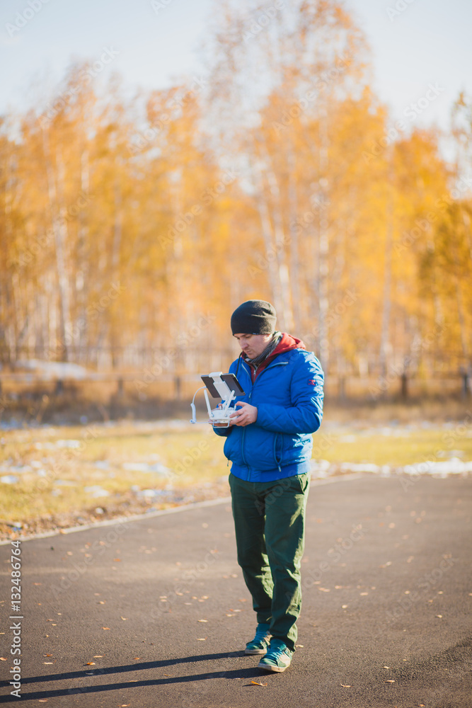 Man manages quadrocopters. Remote control for the drone in the hands of men Man manages quadrocopters. Remote control for the drone in the hands of men