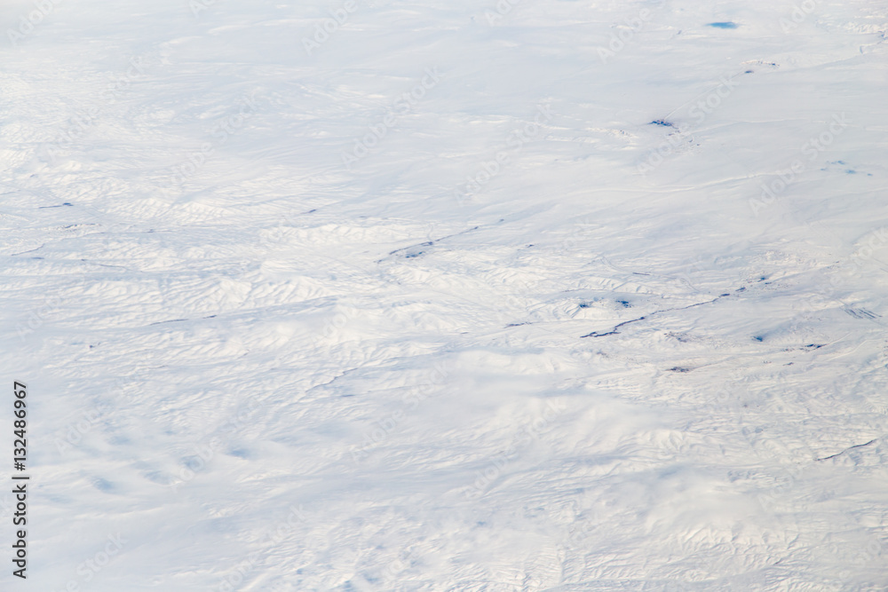 snowy land. view from the airplane as background snowy land. view from the airplane as background